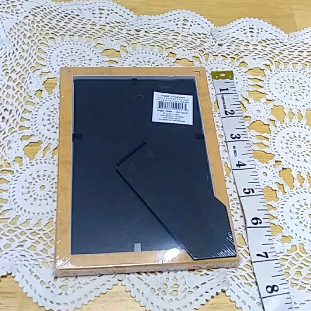 Three small picture frames, new in plastic